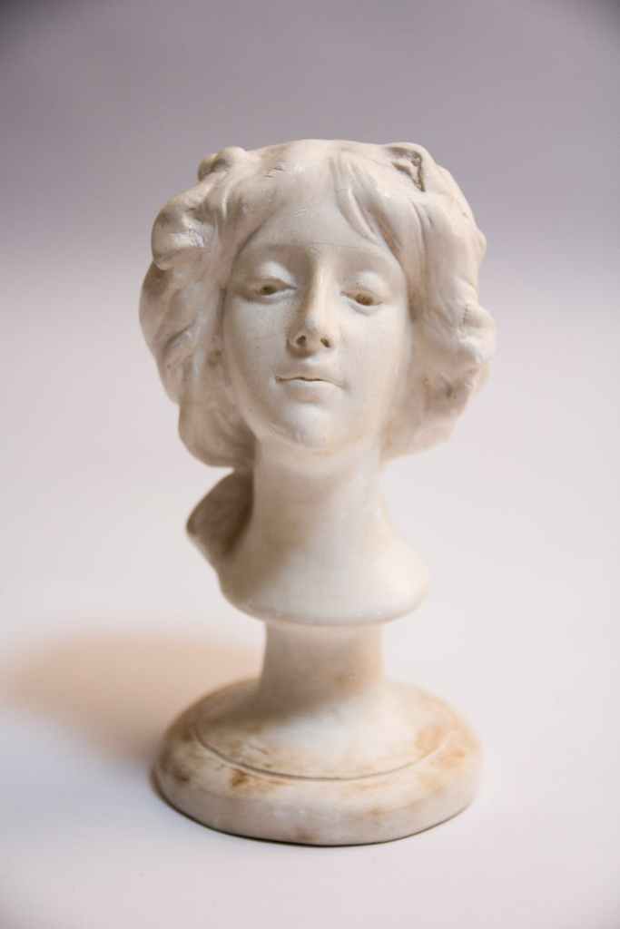 Sculpted bust of a woman's face.